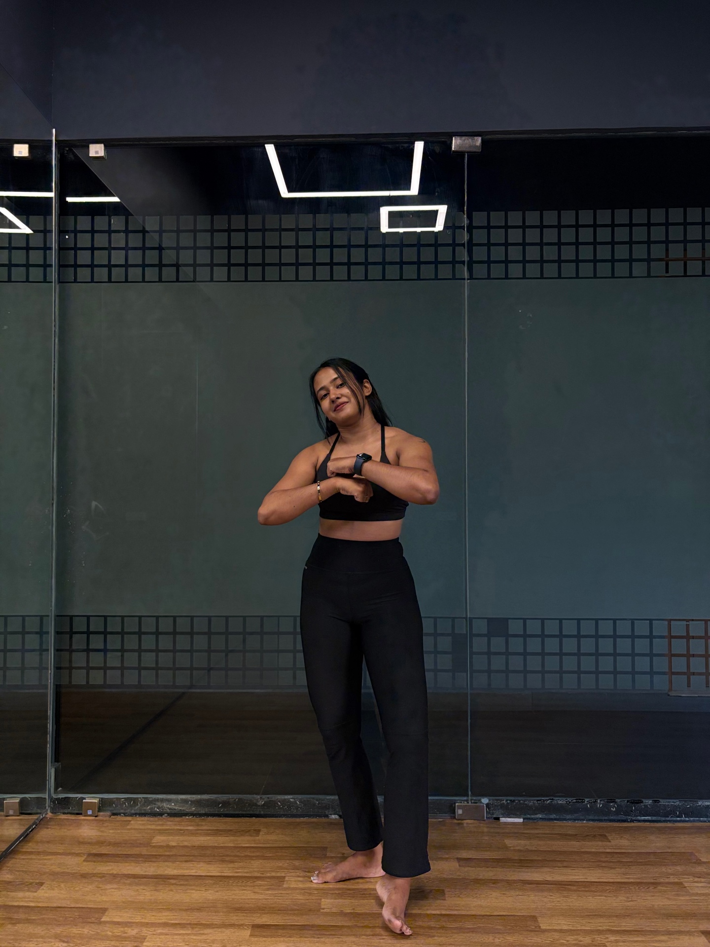 Aswathy in the studio in black activewear