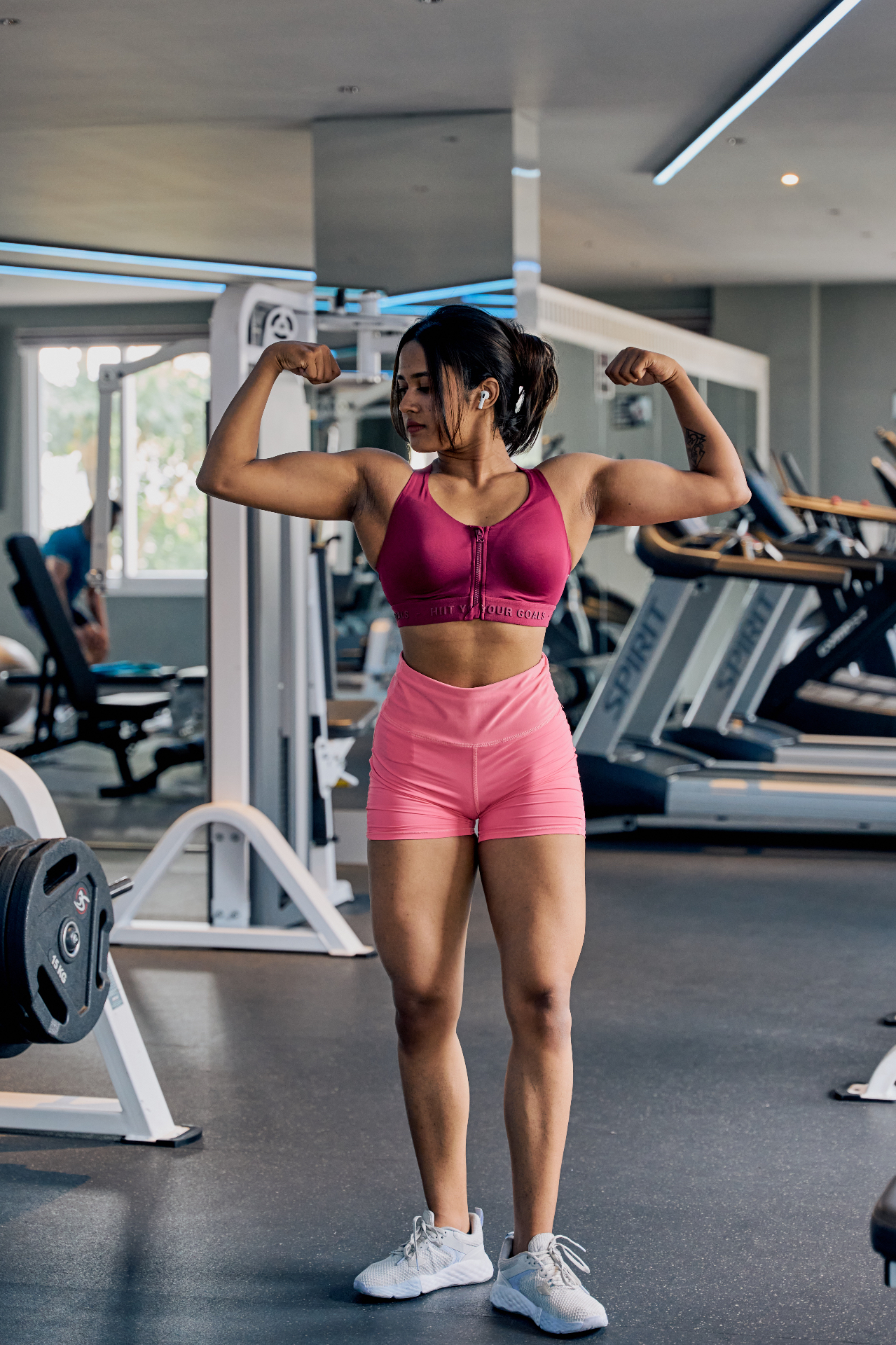 Aswathy posing in the gym